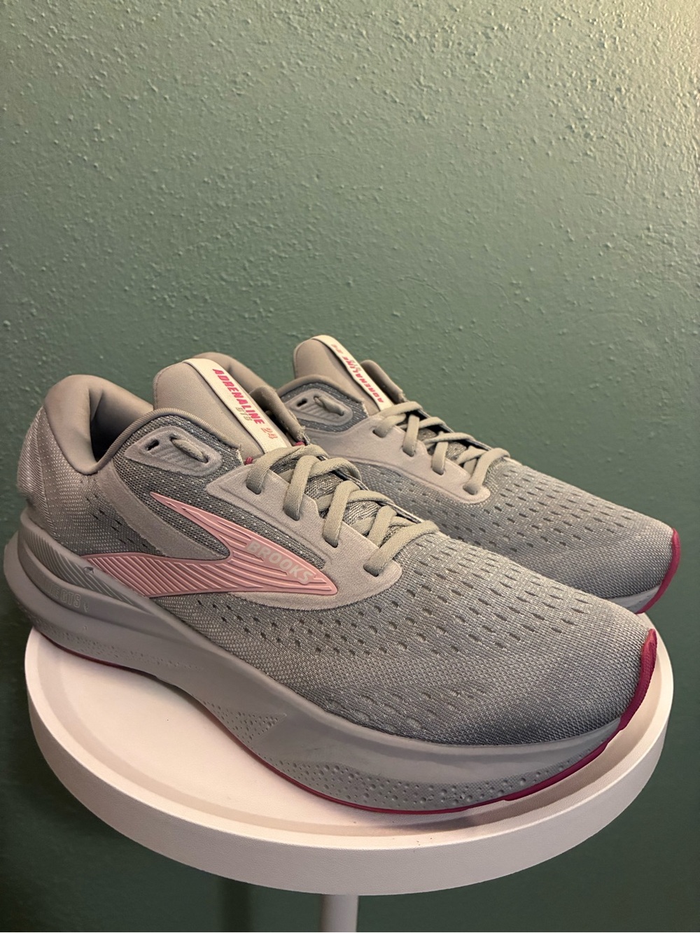 Brooks Adrenaline GTS 24 women’s running shoes in gray with pink accents.